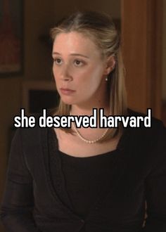 a woman in black shirt with the words she deserved harvard