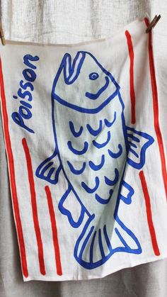 a white towel with a fish on it and red, white, and blue stripes