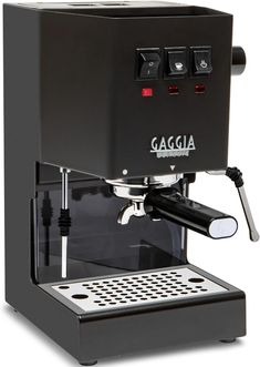 an espresso machine sitting on top of a white table next to a black box