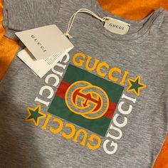 Price Is Firm Gucci Infant Unisex T-Shirt Brand New 12-18 Months Authentic Gucci Cotton T-shirt With Logo Print, Gucci Cotton Tops With Letter Print, Gucci Cotton Tops With Logo Print, Green Cotton Tops With Logo Detail, Gucci Cotton Tops With Embroidered Logo, Gucci Short Sleeve Logo Top, Vinyl Shirt Ideas, Gucci Shirts, Vinyl Shirts