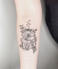 a tattoo on the arm of a woman with books