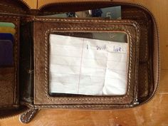 a wallet with a note attached to it