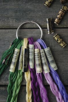 several skeins of yarn are arranged on a wooden table next to some crochet hooks