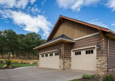 two garages are shown in front of a house with brown siding and stone accents