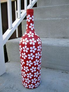 a red and white vase sitting on the steps