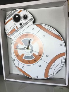 a star wars clock in a box with the face of bb - 8 on it