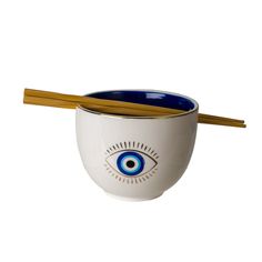 a bowl with chopsticks in it and an eye painted on the side by hand