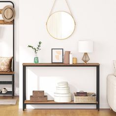 a living room filled with furniture and a mirror on top of a shelf next to a couch