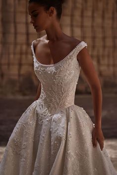 a woman in a white wedding dress is posing for the camera with her hand on her hip