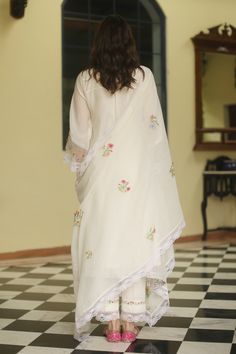 Ivory kurta with thread embroidered yoke in applique flowers. Paired with lace trimmed hem pant. Comes with a chequered floral dupatta and a cotton slip.
Component: 4
Pattern: Applique, Embroidered
Type Of Work: Floral motifs, Thread work, Lace
Neckline: Round neck
Sleeve Type: Full sleeves
Fabric: Kurta: Chanderi, Pant and Slip: Cotton, Dupatta: Kota Doriya fabric
Color: White
Other Details: 
Embroidered yoke
Asymmetrical kurta
French Chantilly lace hemline
Occasion: Destination Wedding - Aza F Wedding Kurta With Embroidered Border In Mulmul, White Mulmul Wedding Sets, White Sharara With Embroidered Border And Straight Kurta, Designer White Saree With Floral Embroidery, Traditional Off White Sharara With Embroidered Border, White Floral Embroidered Dupatta For Eid, White Mulmul Sharara With Floral Embroidery, Diwali White Floral Embroidery Dupatta, White Mulmul Kurta With Dupatta