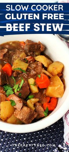 slow cooker gluten free beef stew with carrots, potatoes and parsley in a white bowl