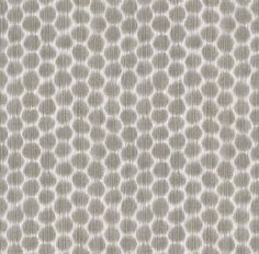 an upholstered fabric with circles in grey and white on the front, as well as