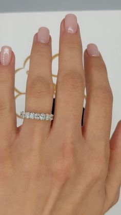 a woman's hand with a diamond ring on it