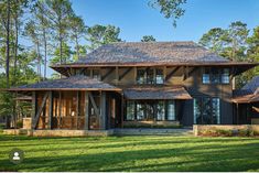 a large house with lots of windows in the front yard