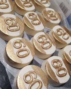 gold and white buttons with the number 60 on them