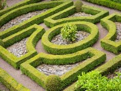 a circular garden design with rocks and stones in the center, surrounded by greenery