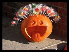 a pumpkin with candy sticks sticking out of it's mouth