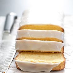 four slices of cake sitting on top of a piece of foil next to a knife