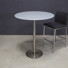 a white table with two black chairs next to it