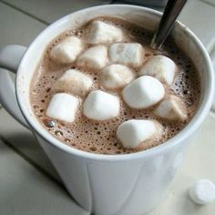 a cup filled with hot chocolate and marshmallows