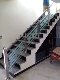 a man standing on the top of a stair case next to a set of stairs