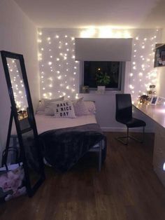 a bedroom with lights on the wall and a bed in front of a large mirror