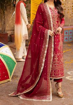 Introducing our New collection 'Chamak Damak' by Asim Jofa designed to make you look and feel your best these pieces will add a touch of class and elegance to your wardrobe. Depths of a precious gemstone, the rich red hue is adorned with the glimmering beauty of gold zariwork and the delicate charm of pink threadwork illuminated by the radiant sparkle of gold cupped sequins. The shirt is adorned with intricate acanthus motifs which tells tales of timeless beauty and grace like whispers of ancient legends. Paired with an embroidered dupatta, it's a journey into a world of enchantment and splendor where every stitch is a testament to the brilliance of craftsmanship and artistry. Embroidered Front Center Panel on Twisted Silk Embroidered Front Side Panel Left and Right on Twisted Silk Embroid Transitional Festive Dress With Naqshi Detail, Elegant Red Dress With Mirror Work, Red Naqshi Dress For Festivals, Naqshi Dupatta For Party, Festive Naqshi Dresses, Bohemian Dupatta For Celebration, Red Naqshi Kurta, Elegant Party Dress With Naqshi Details, Transitional Celebration Dress With Dupatta