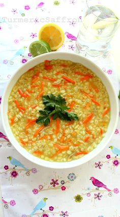 a bowl of soup with carrots and cilantro