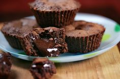 chocolate muffins on a plate with one cut in half