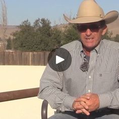 a man sitting in a chair wearing a cowboy hat