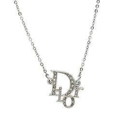 This is part of Chairish’s Costume Jewelry assortment.  DIOR Oblique Crystal Silver Tone Necklace   This silver tone necklace from Dior features a sparkling pendant suspended on a slender chain. Gracefully designed, the pendant is crystal encrusted D.I.O.R lettering. Its design is completed with a silver tone medallion dangling from the lobster clasp.    Material: Silver   This item has been used and may have some minor flaws. Before purchasing, please refer to the images for the exact condition of the item.  Please refer to the dimensions in the description above for accurate measurements. Please reach out to the seller with any questions on dimensions or fit prior to purchase.  We cannot confirm the time period listed.  A return request must be submitted within 48 hours after delivery. C Dior Necklace Silver, R Lettering, Art Deco Pendant Necklace, White Gold Pendant Necklace, Vintage Pendant Necklace, Contemporary Necklace, Dior Oblique, Art Deco Pendant