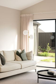 a living room filled with furniture and a sliding glass door