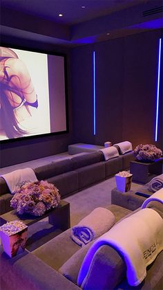 a large screen in a room with couches and pillows