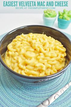 macaroni and cheese in a bowl on a blue place mat