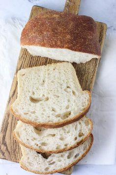 four slices of bread sitting on top of a cutting board