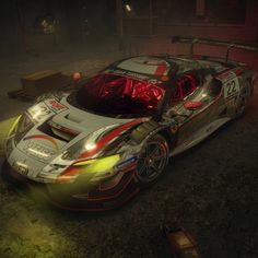 an image of a car that is in the middle of a race track with lights on