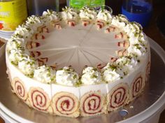 a cake sitting on top of a white plate covered in frosting and sprinkles