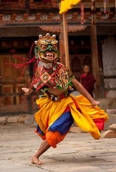 a man in an elaborate costume is dancing