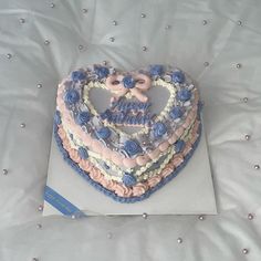 a heart shaped cake with blue and pink frosting