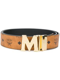 Cognac brown canvas/leather Claus M reversible belt from MCM featuring coated finish, leather trim, gold-tone buckle fastening, pre-drilled holes, all-over logo print and detachable buckle. | MCM Claus M reversible belt Brown Leather Belt Buckles With Logo Plaque, Brown Leather Belt Buckle With Logo Plaque, Brown Leather Belt With Logo Plaque, Designer Brown Belt Buckles With Gold Buckle, Designer Brown Belt Buckles, Gold Leather Belt Buckle With Logo Plaque, Designer Brown Belt With Gold Buckle, Brown Leather Belt With Gold-tone Logo Plaque, Luxury Leather Belt With Logo Strap