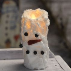 Bring a little Frosty into your home with this Snowman Timer candle. The timer candle features a coated wax finish with a snowman face. The timer features a 6 hour on 18 hour off setting. Round small measures 4" R x 4" H. Round large measures 5" R x 5" H. Votive measures 2" x 5" H. Small operates on Button Battery (included). Large operates on 2 AA (not included). Farmhouse Snowman, Custom Floating Shelves, Timer Candles, Primitive Snowman, Rag Garland, Round Candles, Primitive Snowmen, Wholesale Home Decor, Snowman Faces