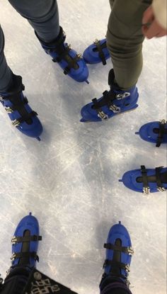 the legs and feet of people wearing blue snow boots