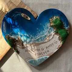 a heart shaped plate with an ocean scene on it