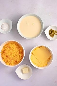 several bowls with cheese and other ingredients in them