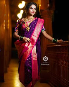 a woman in a purple and pink sari