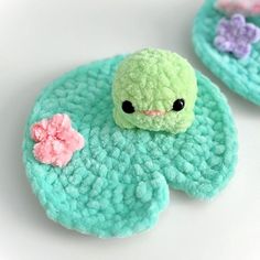 there are two crocheted items with flowers on them