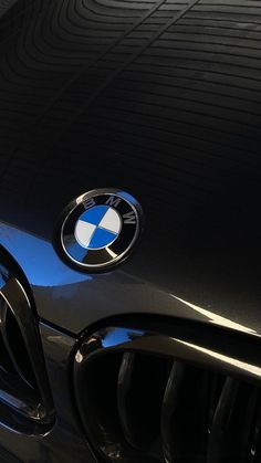 the front end of a bmw car with its emblem on it's grills