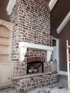 a brick fireplace in the middle of a room