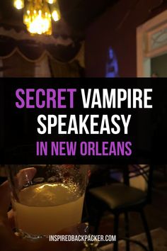 a person holding a glass in their hand with the words secret vampire speakeasy in new orleans