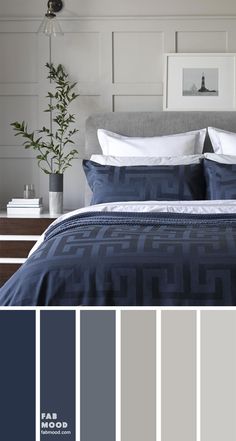 a bedroom with blue and gray colors in the bed, nightstands and wall art